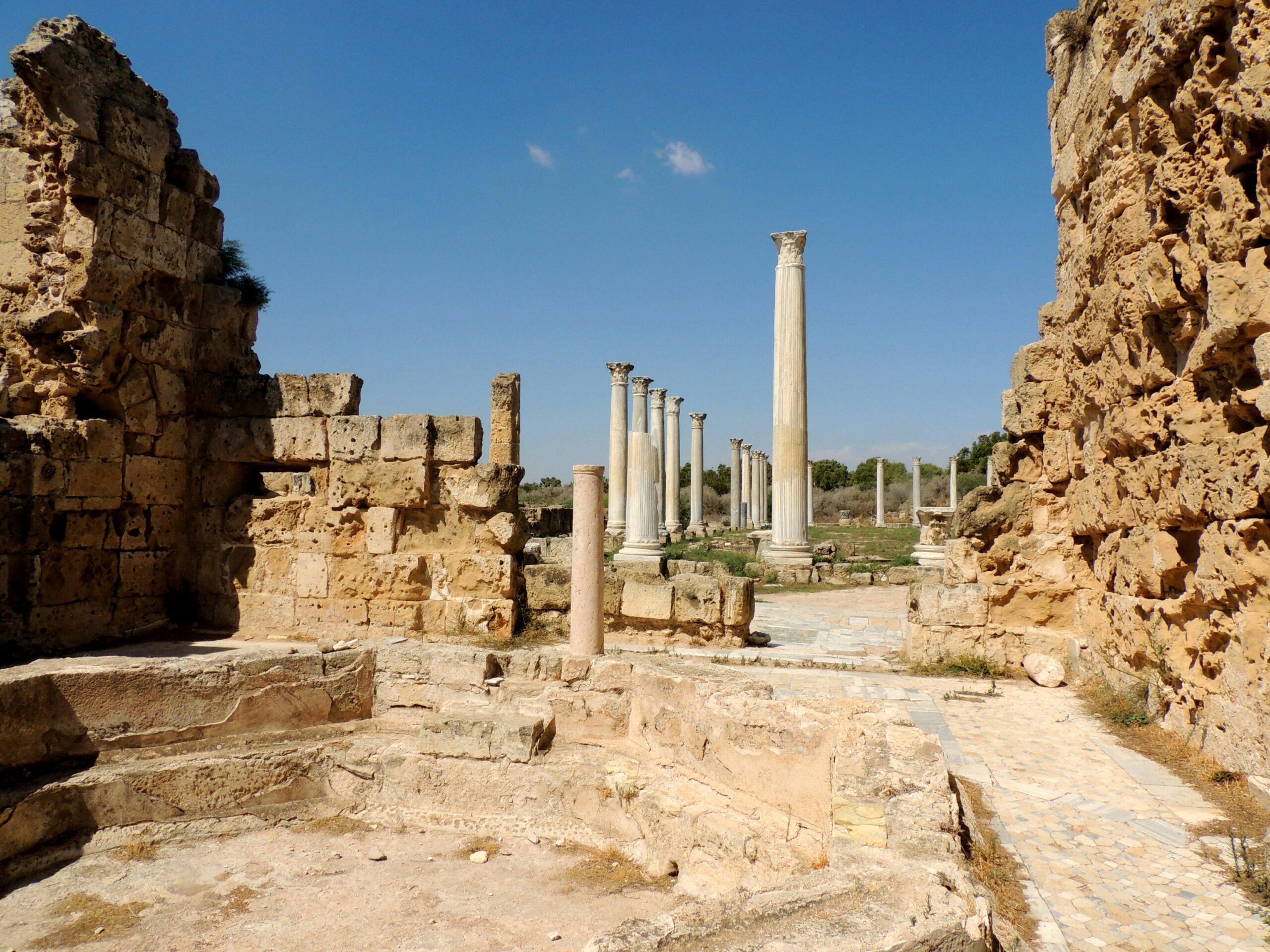 Explore the ancient ruins and columns in Salamina, Greece, under a clear blue sky.