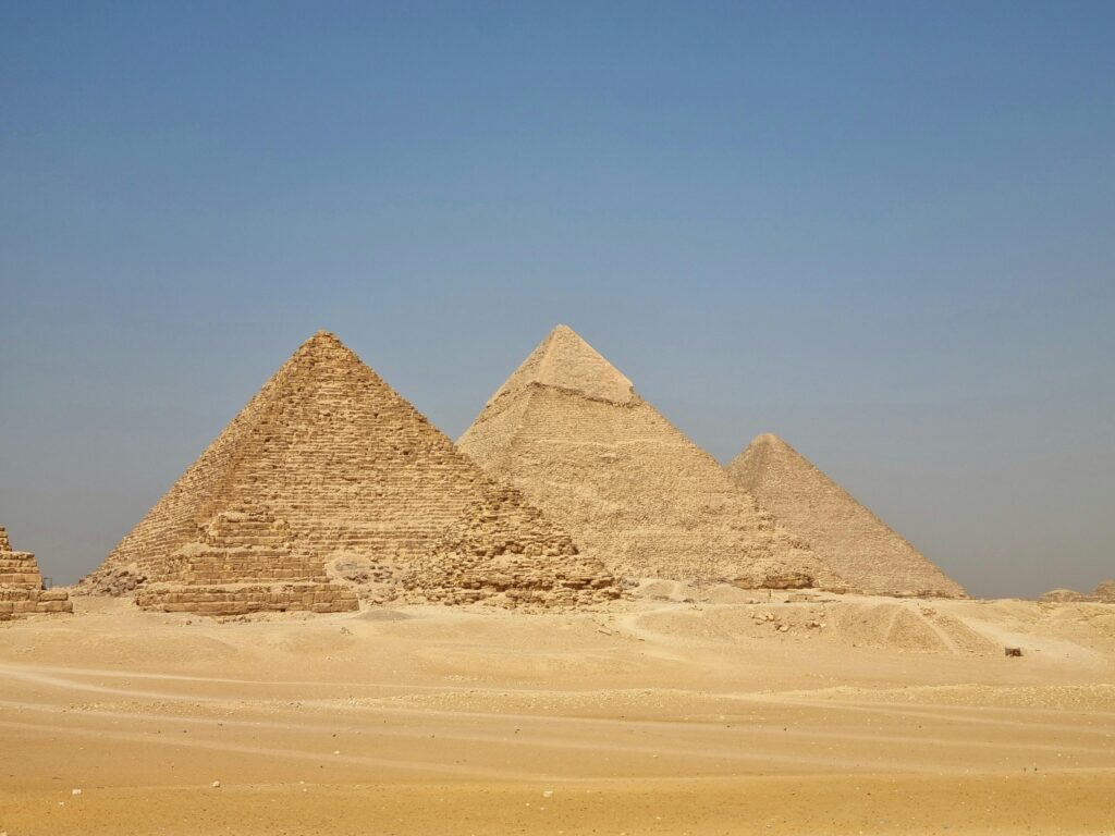 A stunning view of the Pyramids of Giza under a clear blue sky, showcasing Egypt's ancient heritage.