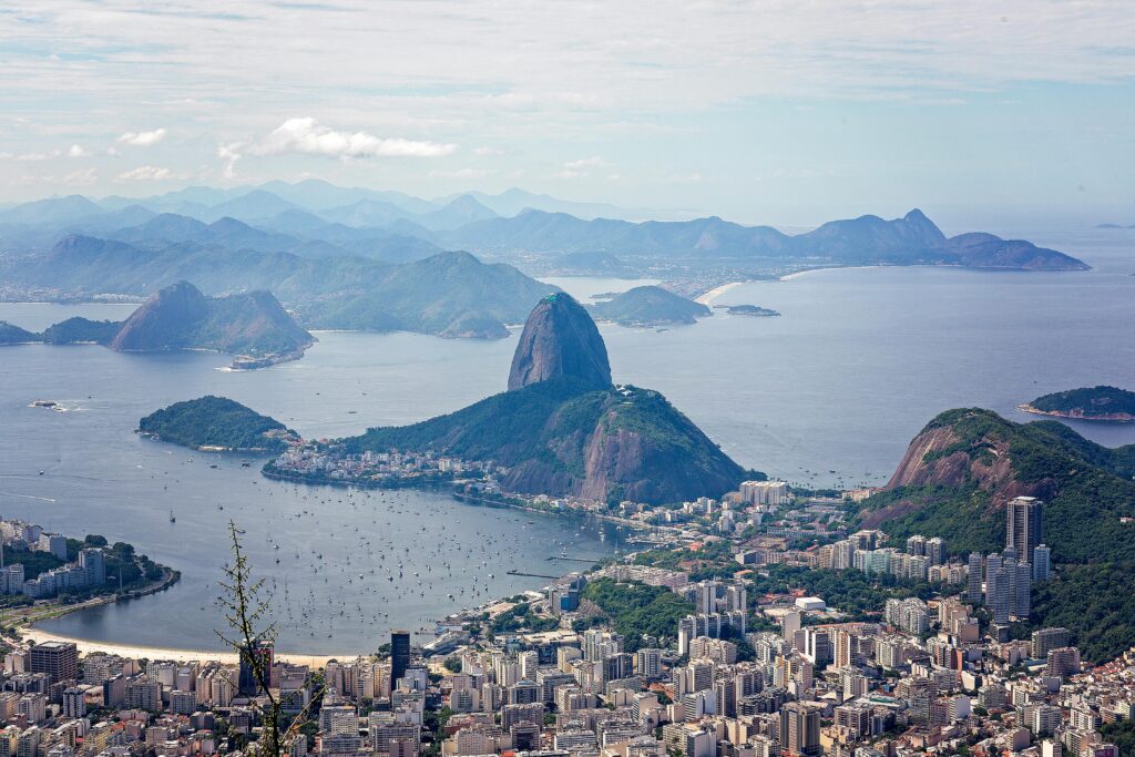 A breathtaking aerial view of Rio de Janeiro featuring Sugarloaf Mountain and Guanabara Bay.