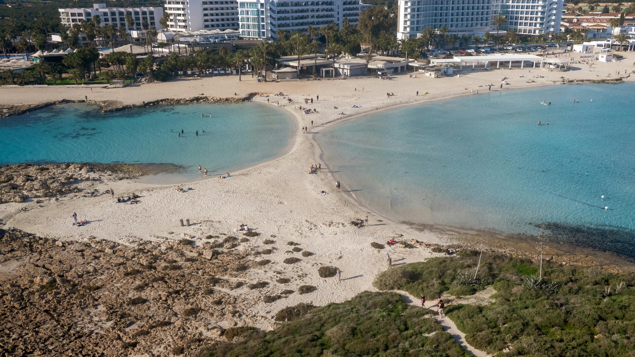 A beautiful aerial view of Nissi Beach in Cyprus with crystal clear waters and sandy shores.