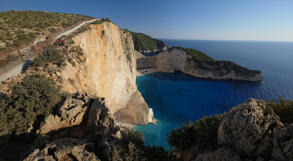 Stunning aerial view of Navagio Beach's cliffs and turquoise waters on Zakynthos Island, Greece.