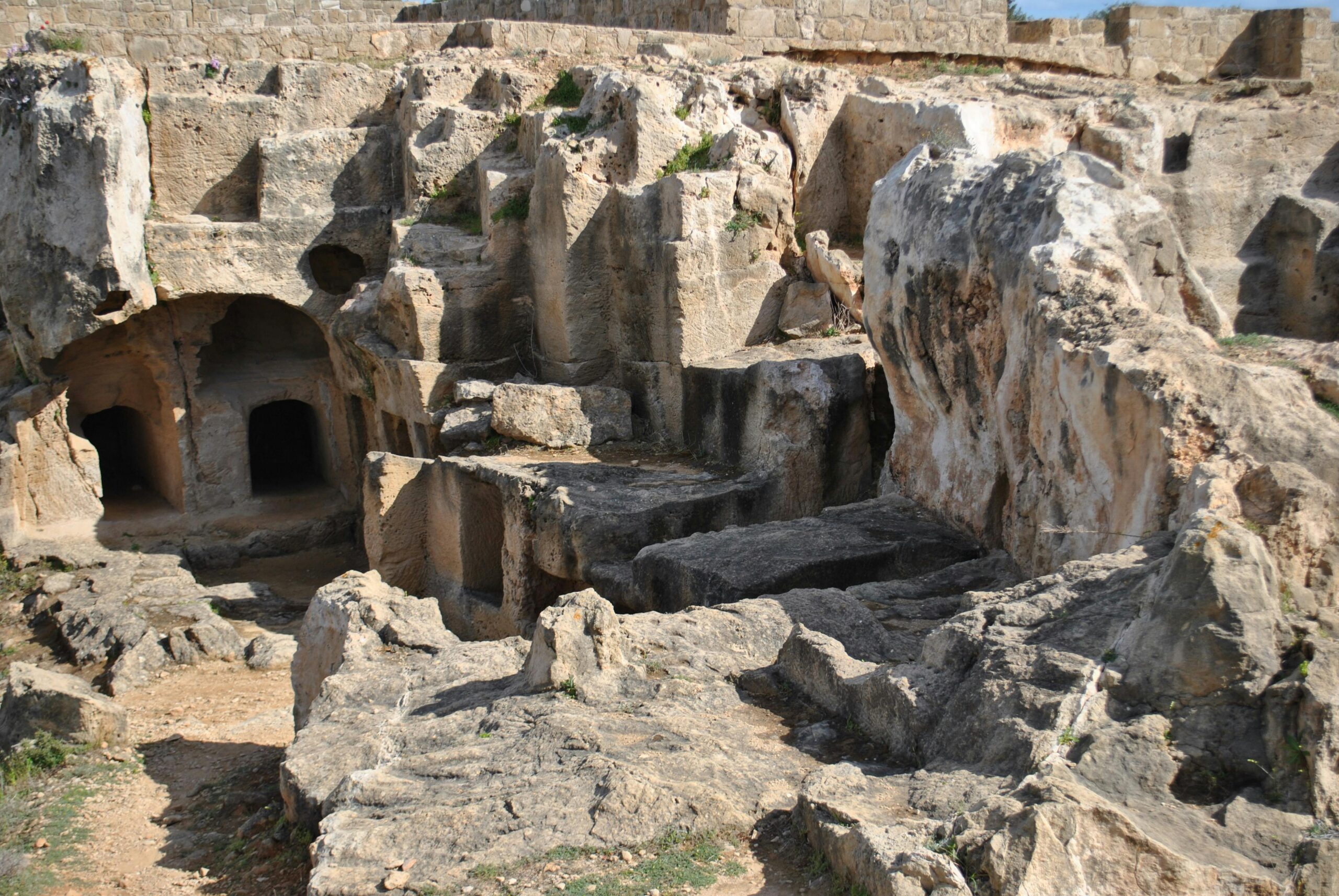 Explore the ancient rock-cut tombs in Cyprus, showcasing historical archaeology and rugged stone formations.