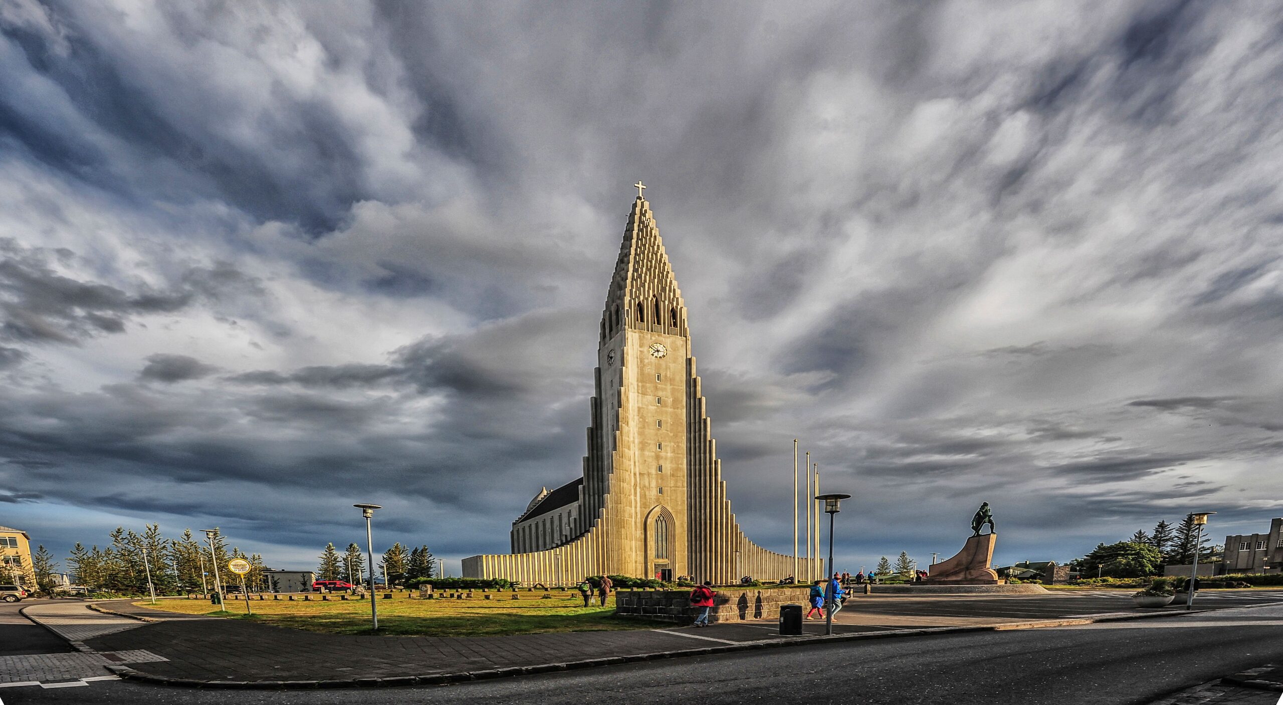 Stunning view of Hallgrimskirkja with dramatic clouds in Reykjavík, Iceland, capturing its gothic architecture.